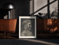 Black-framed Man wearing laurel wreath in profile print on a moody console with designer coffee-table books