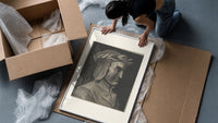 Man wearing laurel wreath in profile framed print being unpacked from protective bubble wrap and a box