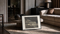 Charon ferrying damned souls print in a slim black frame leaning on a travertine coffee table