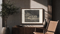 Charon ferrying damned souls print in a wood frame above a fluted sideboard beside an olive tree