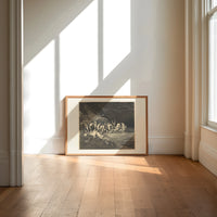 Charon ferrying damned souls print in an oak frame on a sunlit wood floor beneath tall window light