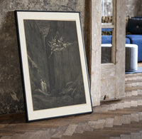 Demons on cliff, two robed travelers print in a black frame leaning beside a vintage door on parquet