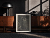 Black-framed Demons on cliff, two robed travelers print on a moody console with designer coffee-table books