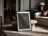 Demons on cliff, two robed travelers print in a black frame leaning on a travertine table in a sunlit lounge