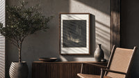 Figure rising from tomb in hell poster framed above a fluted sideboard beside an olive tree