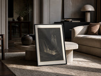 Figure rising from tomb in hell print in a black frame leaning on a travertine table in a sunlit lounge
