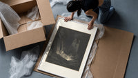 Figure rising from tomb in hell framed print being unpacked from protective bubble wrap and a box