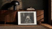 Starving prisoners in dungeon print in a black frame leaning against a walnut console in lamplight