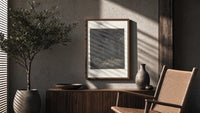 Two figures overlooking pit of souls poster framed above a fluted sideboard beside an olive tree