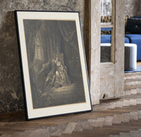 Lovers embracing on ornate throne print in a black frame leaning beside a vintage door on parquet