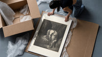 Giant crouching over two small figures framed print being unpacked from protective bubble wrap and a box