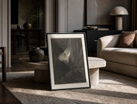 Two robed figures in rocky gorge print in a black frame leaning on a travertine table in a sunlit lounge