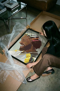 Drake Colorful Hair Clips Portrait poster being unrolled on a concrete floor