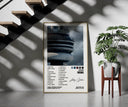 Drake Views framed print on a staircase entryway wall beside a plant