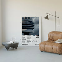 Drake Views poster framed above a tan leather living-room couch
