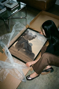 The Giant KAWS Companion sculpture in desert poster shown across its range of print sizes