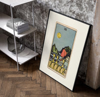 Figure walking away from eight cups poster in a black frame leaning beside a shelf in a raw-plaster loft