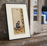 Craftsman carving pentacle coins print in a black frame leaning beside a vintage door on parquet