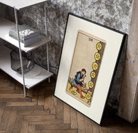 Craftsman carving pentacle coins poster in a black frame leaning beside a shelf in a raw-plaster loft