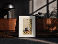 Black-framed Craftsman carving pentacle coins print on a moody console with designer coffee-table books