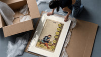 Craftsman carving pentacle coins framed print being unpacked from protective bubble wrap and a box
