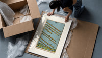 Eight flying wands over landscape framed print being unpacked from protective bubble wrap and a box