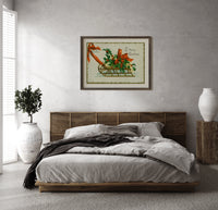 Christmas sled with holly and ribbon print in a dark wood frame above a rattan bed on a plaster wall