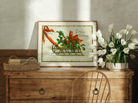 Christmas sled with holly and ribbon print in an oak frame on a farmhouse dresser beside white tulips