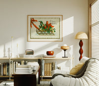 Christmas sled with holly and ribbon print in an oak frame above a mid-century book console with a vintage radio