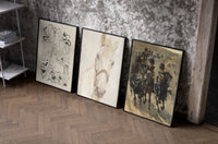 Horses and mounted cavalry soldiers set of three black-framed prints leaning against a raw-plaster wall