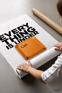 Woman unboxing Everything Is Under Ctrl Funny Office poster from cardboard box with bubble wrap on concrete floor