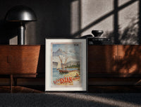 Black-framed sailboats on alpine lake bay print on a moody console with designer coffee-table books