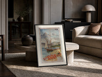Sailboats on alpine lake bay print in a black frame leaning on a travertine table in a sunlit lounge