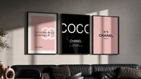 Chanel Wall Art Set triptych in three black frames on a grey wall above a leather sofa