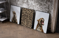 Leopard Print Wall Art Set set of three black-framed prints leaning against a raw-plaster wall
