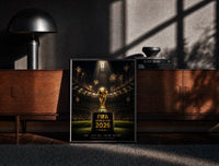Black-framed FIFA World Cup trophy on pedestal print on a moody console with designer coffee-table books