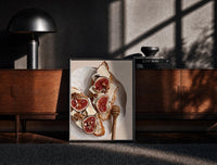 Black-framed Figs, Cheese and Walnuts print on the floor in front of a dark wooden console