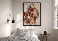 Figs, Cheese and Walnuts print in a black frame above a bed with striped linens, a brass wall lamp and a sunlit window