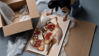 Figs, Cheese and Walnuts framed print being unpacked from protective bubble wrap and a box