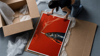 Fish Smoking a Cigarette framed print being unpacked from protective bubble wrap and a box
