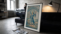 Japanese figure holding parasol and soap print in a slim black frame leaning on a dark sofa in a concrete print studio