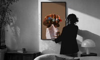 Fist with a Blue Gemstone Ring print in a slim black frame being hung on a sunlit wall in a monochrome room