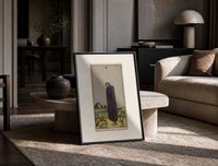 Cloaked figure among spilled cups print in a black frame leaning on a travertine table in a sunlit lounge