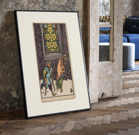 Two beggars passing lit stained-glass window print in a black frame leaning beside a vintage door on parquet