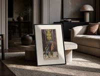 Two beggars passing lit stained-glass window print in a black frame leaning on a travertine table in a sunlit lounge