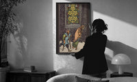 Five of Pentacles print in a slim black frame being hung on a sunlit wall in a monochrome room