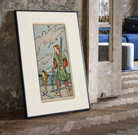 Man collecting swords by shore print in a black frame leaning beside a vintage door on parquet
