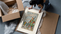 Man collecting swords by shore framed print being unpacked from protective bubble wrap and a box