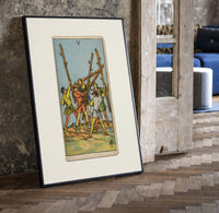 Five men fighting with staves print in a black frame leaning beside a vintage door on parquet