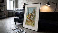 Five men fighting with staves print in a slim black frame leaning on a dark sofa in a concrete print studio